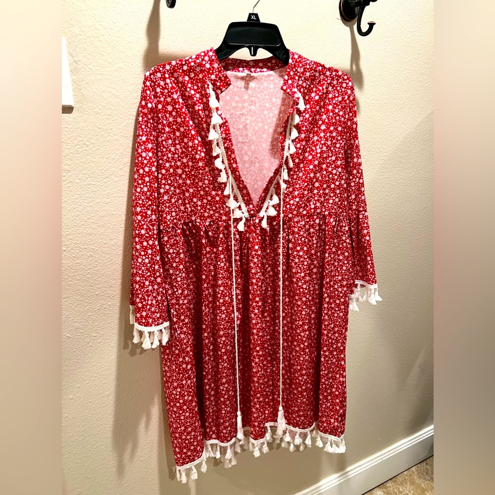 Red midi dress with white tassel trim.